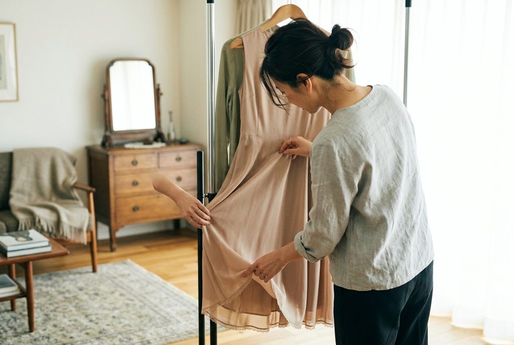 女性がレンタルドレスの裾を注意深く確認する手元